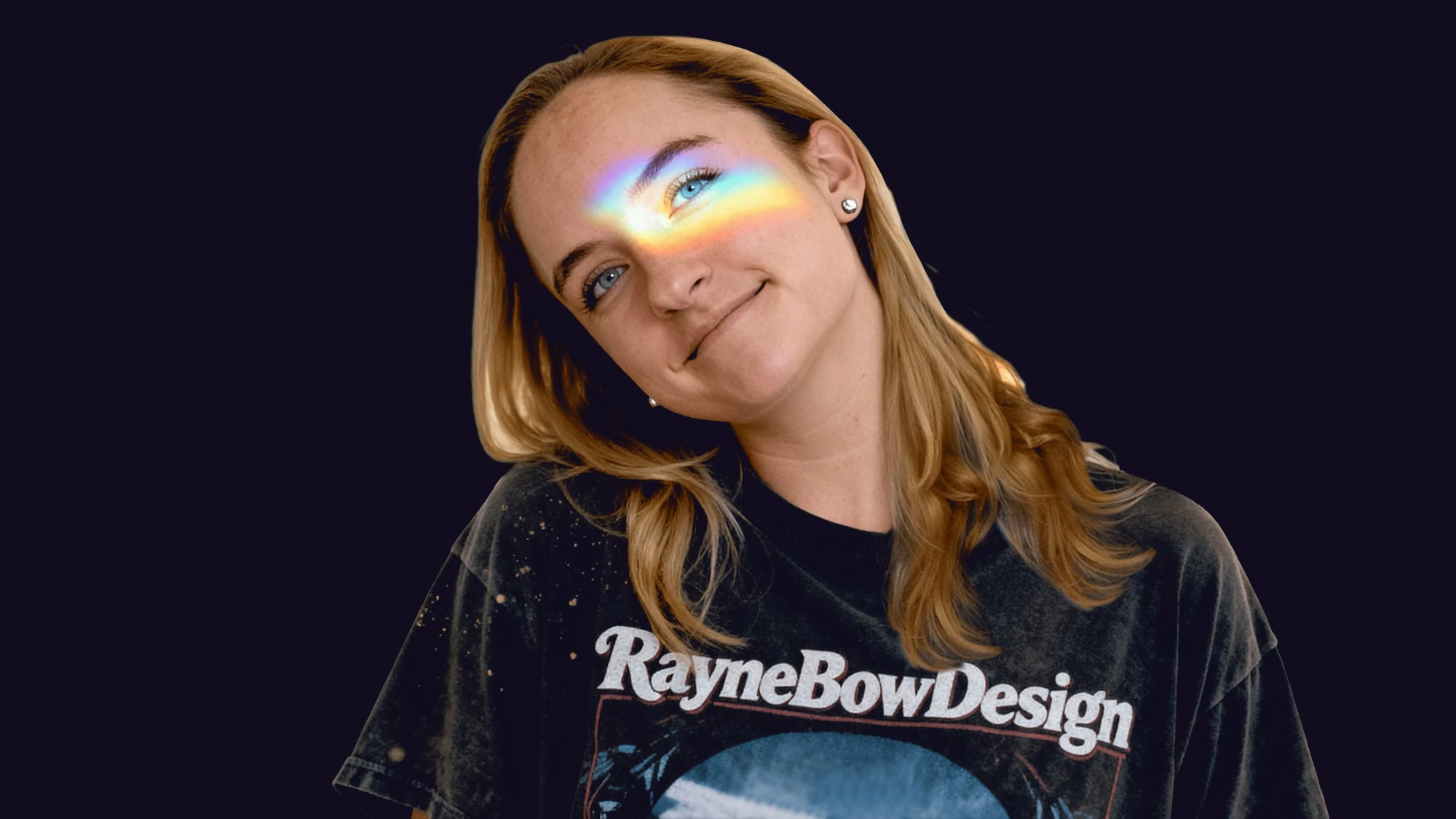 Rayne Scheepers wearing a RayneBowDesign tee, with a rainbow light strip across her eyes